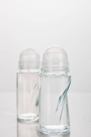 selective focus of bottles of deodorant isolated on whiteの写真素材