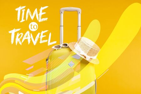 yellow colorful travel bag with sunglasses and straw hat isolated on yellow with time to travel illustrationの写真素材