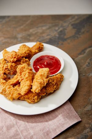 delicious chicken nuggets with ketchup on stone surfaceの写真素材