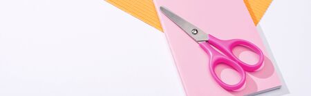 panoramic shot of scissors, notebook and paper on white backgroundの写真素材