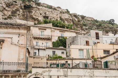 old small buildings near green plants in scicly, italyの写真素材