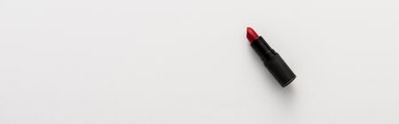 panoramic shot of black tube with red lipstick on white with copy spaceの写真素材