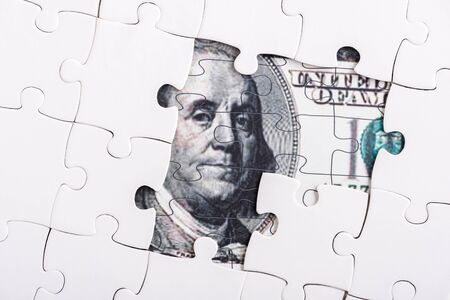 close up of puzzle pieces of dollar banknoteの写真素材