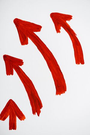 red and drawn directional arrows showing up and left on whiteの写真素材