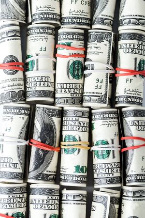 top view of cash rolls with colorful rubber bands