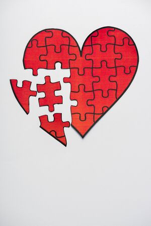 top view of drawn red heart shape jigsaw isolated on white with copy spaceの写真素材