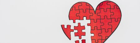 panoramic shot of drawn red heart shape puzzles isolated on whiteの写真素材