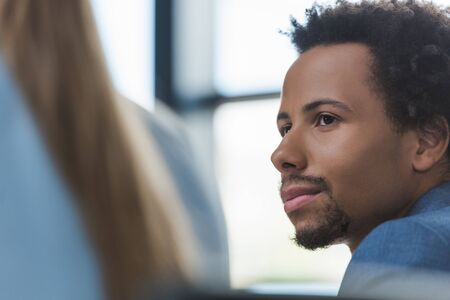 selective focus of thoughtful african american businessman at business meeting