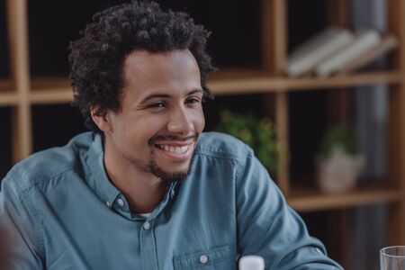 cheerful african american businessman smiling in office