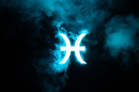 blue illuminated Pisces zodiac sign with smoke on backgroundの写真素材