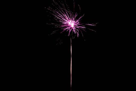 pink festive firework on party, isolated on blackの写真素材
