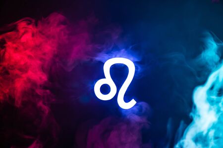 blue illuminated Leo zodiac sign with colorful smoke on backgroundの写真素材