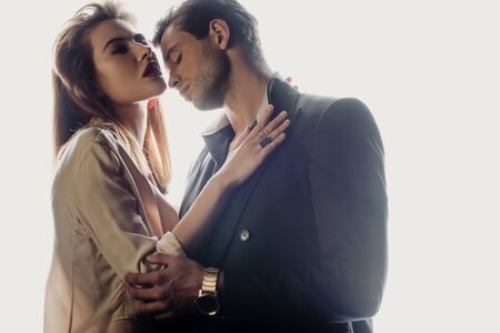 attractive woman hugging with handsome man isolated on whiteの写真素材