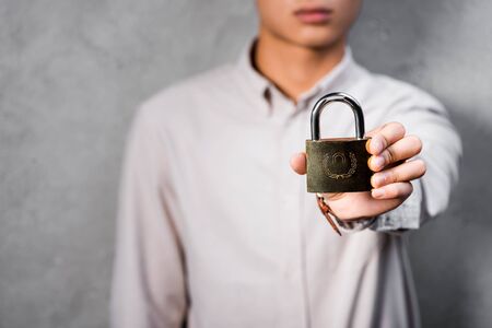 cropped view of seo manager holding metal padlock in officeの写真素材