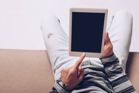 partial view of man using digital tablet with blank screen isolated on greyの写真素材