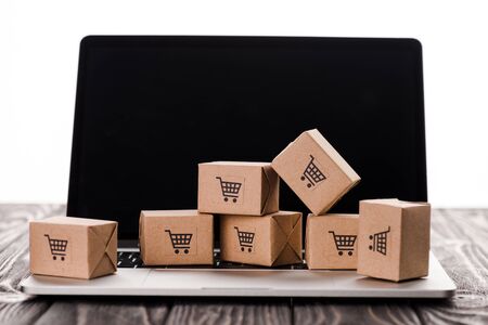 toy boxes on laptop with blank screen isolated on white, e-commerce concept