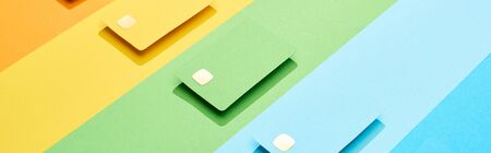 multicolored empty credit cards on rainbow background, panoramic shot