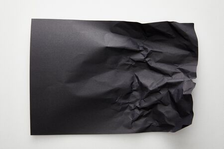 top view of empty crumpled black paper on white backgroundの写真素材