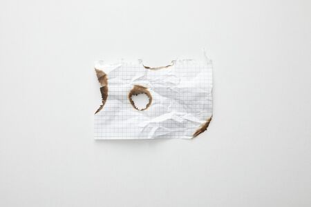 top view of empty crumpled and burnt vintage paper on white backgroundの写真素材