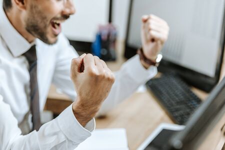 cropped view of bi-racial happy trader showing yes gestureの写真素材