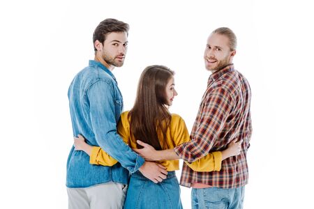 back view of three smiling young friends hugging isolated on whiteの写真素材