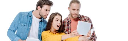 shocked girl taking selfie on digital tablet near friends isolated on white, panoramic shot