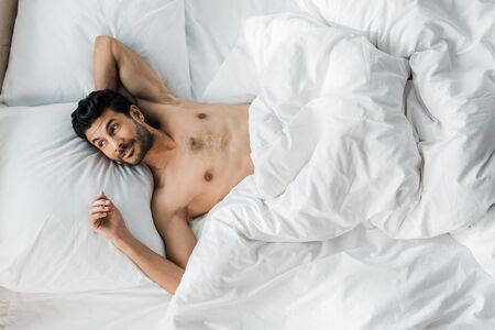 top view of sexy and handsome bi-racial man waking up in morningの写真素材