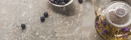 top view of blueberries, herbal tea on grey concrete surface, panoramic shotの写真素材