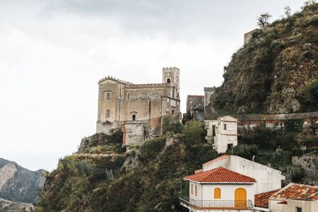SAVOCA, ITALY - OCTOBER 3, 2019: Church of San Nicolo on hill near small housesのeditorial素材