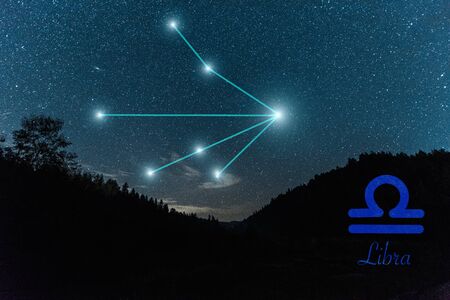 dark landscape with night starry sky and libra constellationの写真素材