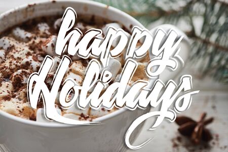 close up view of Christmas cacao with marshmallow and cacao powder in mug with happy holidays illustrationの写真素材