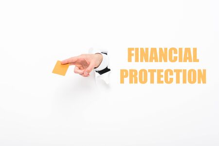 Cropped view of man holding empty business card from hole in white paper with financial protection illustrationの写真素材