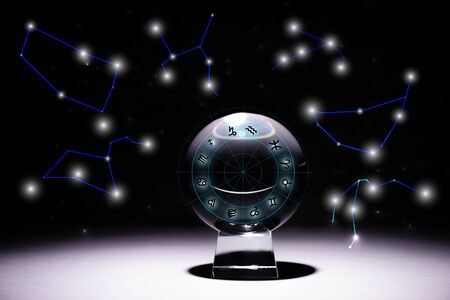 crystal ball with zodiac signs isolated on black with constellationsの写真素材