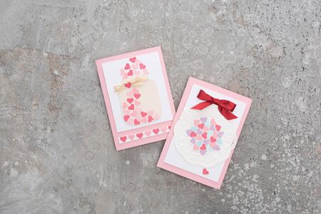 top view of valentines greeting cards on concrete grey background