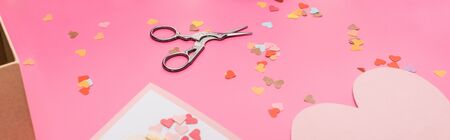 valentines confetti, scissors, cards on pink background, panoramic shotの写真素材