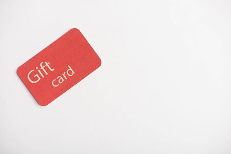 Top view of gift card on white surface with copy spaceの写真素材