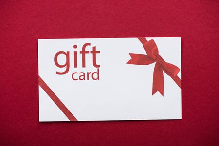 Top view of gift card on red backgroundの写真素材