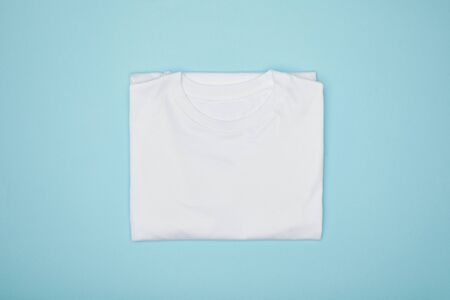 top view of blank basic white t-shirt isolated on blueの写真素材