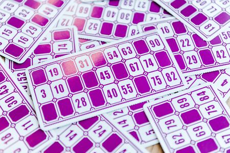 top view of purple lottery tickets with numbers on surface