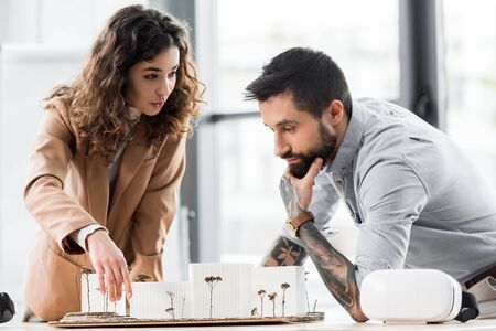 virtual reality architect pointing with finger and talking with colleague