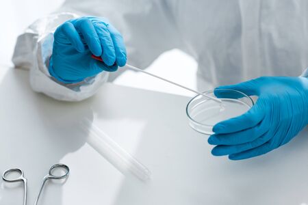Cropped view of scientist in latex gloves doing dna test in lab