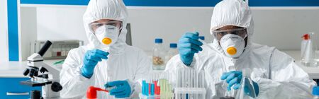 panoramic shot of multicultural scientists doing dna test in lab