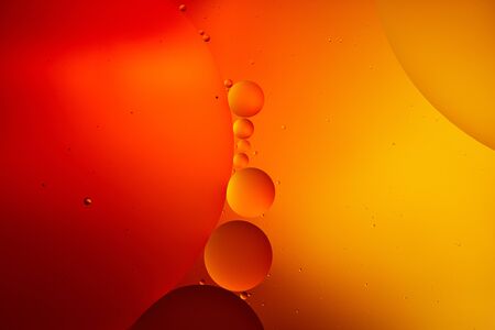 creative abstract orange and red color background from mixed water and oilの写真素材