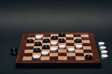 Checkerboard with black and white checkers isolated on black 