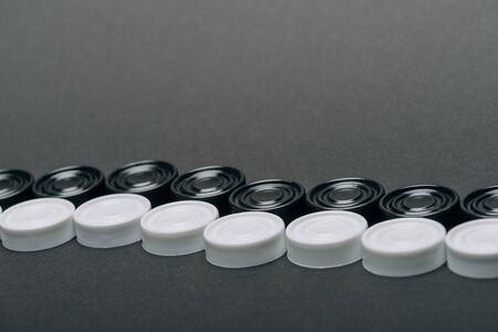 Lines of white and black checkers isolated on greyの写真素材