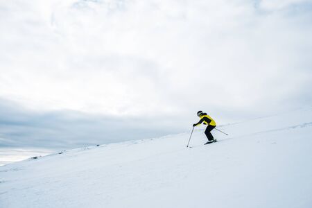 sportsman in helmet skiing in wintertimeの写真素材