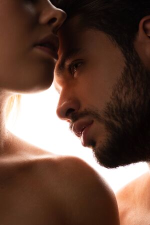 close up silhouette of sensual naked couple, isolated on whiteの写真素材