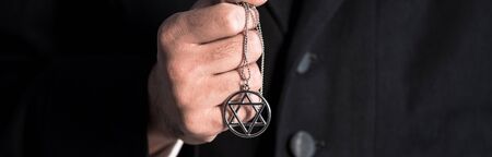panoramic shot of jewish man holding star of david necklaceの写真素材