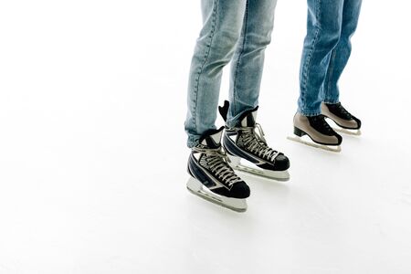 cropped view of young couple in skates skating on rinkの写真素材