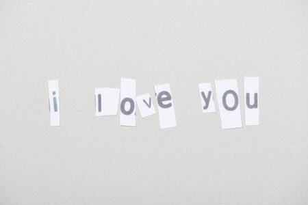 Top view of i love you lettering on papers isolated on grey